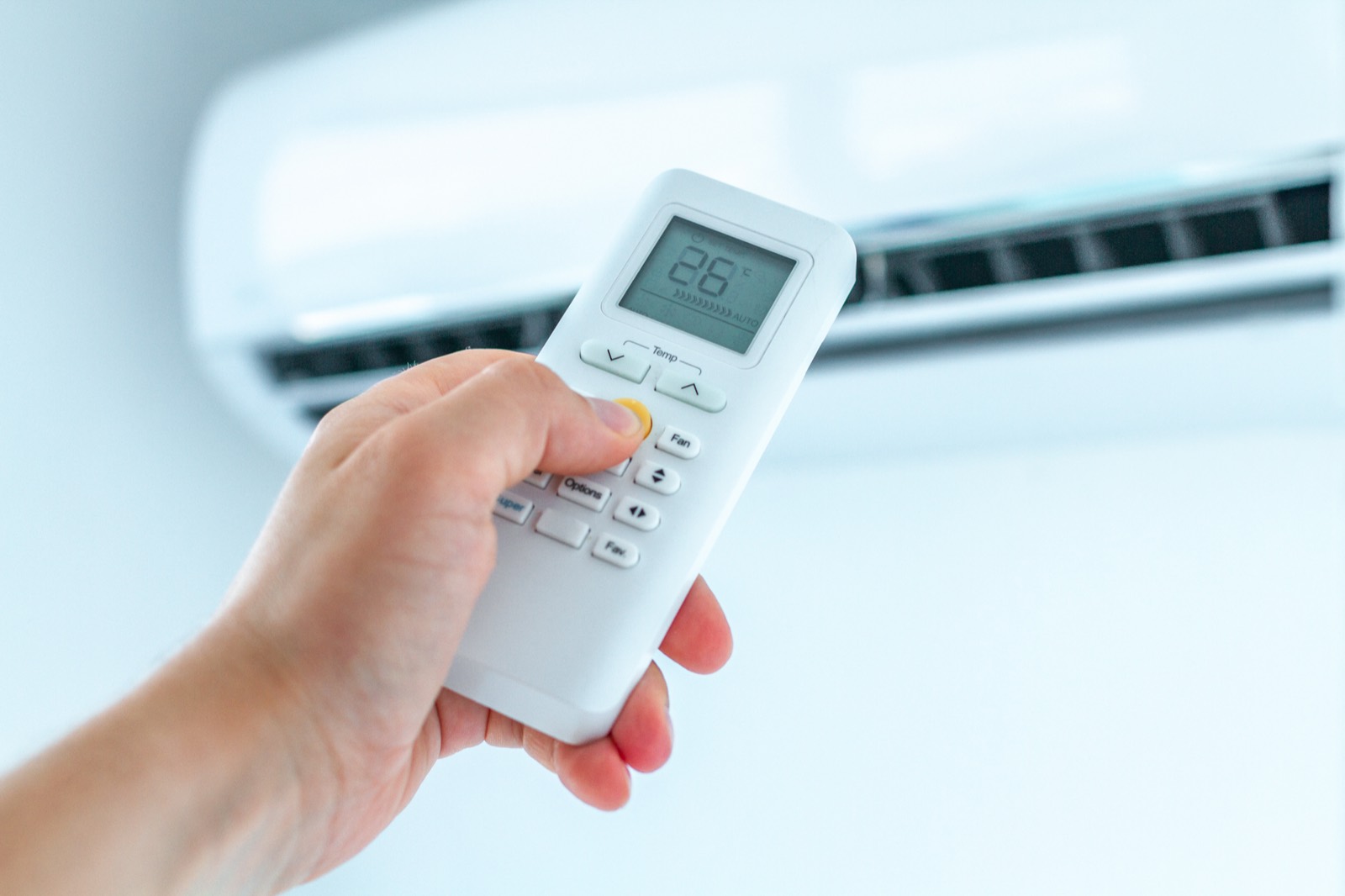 Adjusting a wall mounted air conditioning unit with a remote control