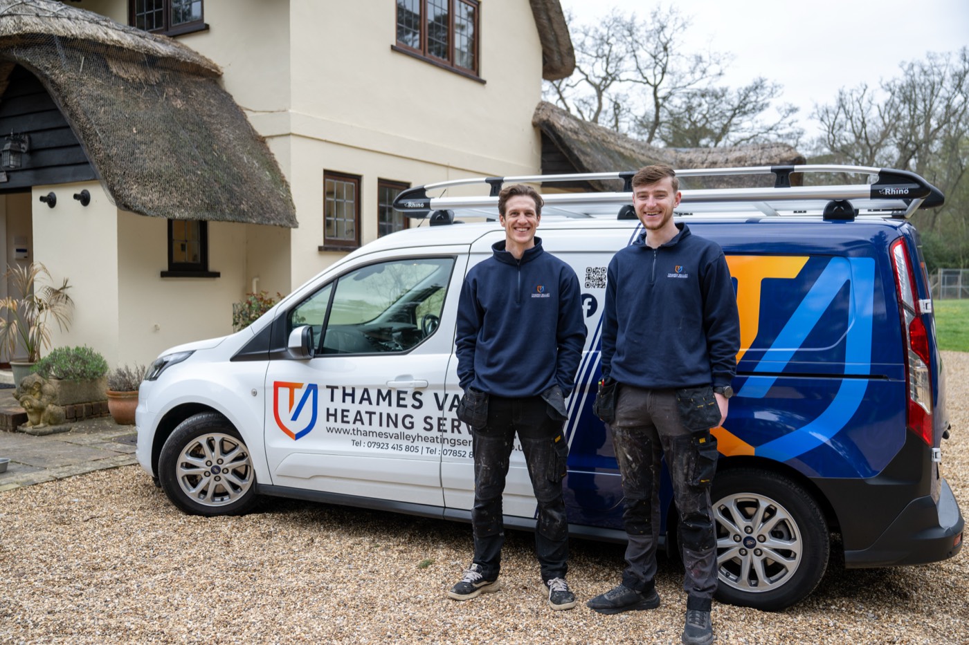 Two Thames Valley Heating & Cooling engineers with the company van outside a customer home